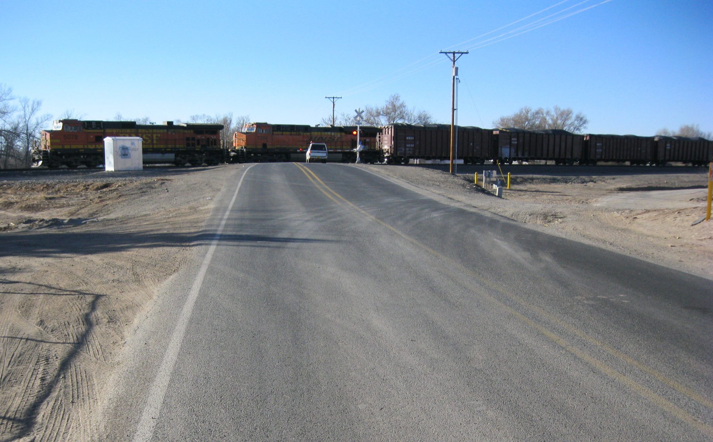 Road leading to train on tracks